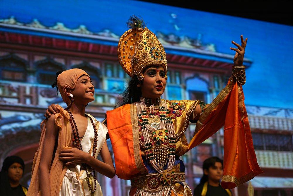 Children performing a Gita scene on stage