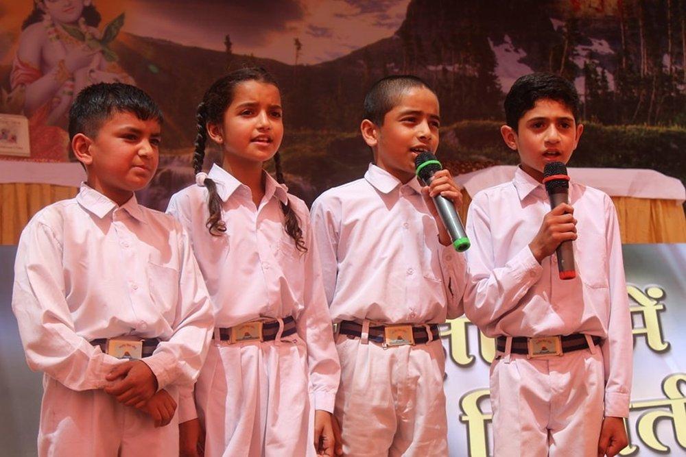 Students speaking at the microphone on stage